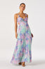 Woman wearing a pastel floral dress on a white background